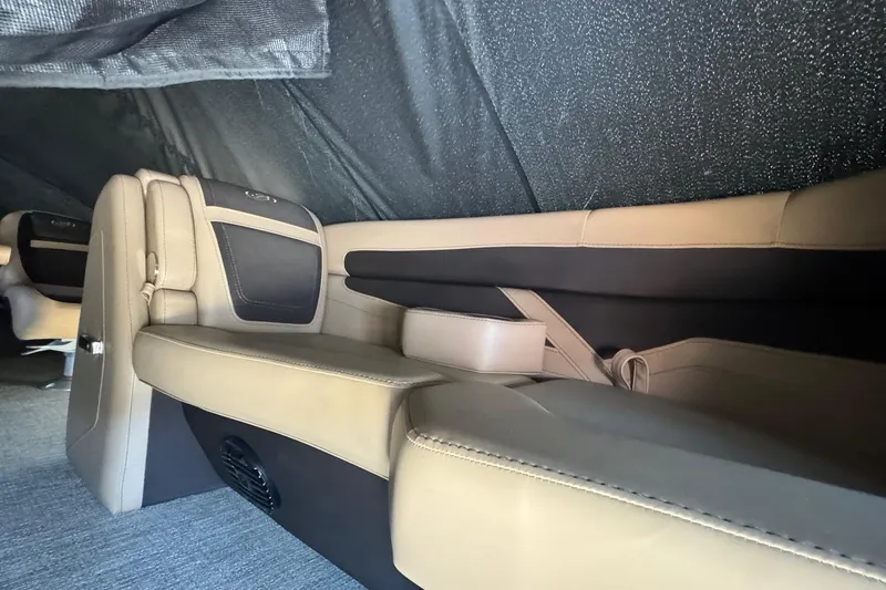 Slide: The Image of 2023 Barletta Cabrio 22UC interior with beige and black seating under a canopy. - 13