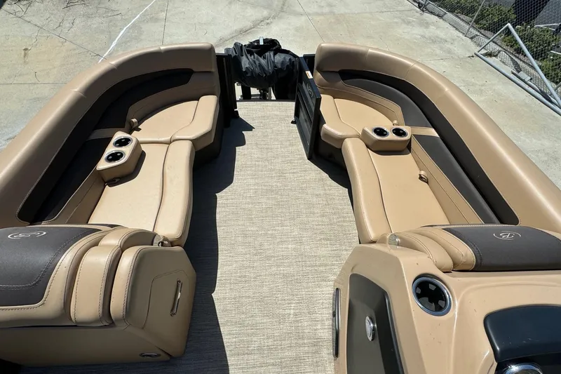 Slide: The Image of 2023 Barletta Cabrio 22UC boat interior with tan seating and cup holders. - 14