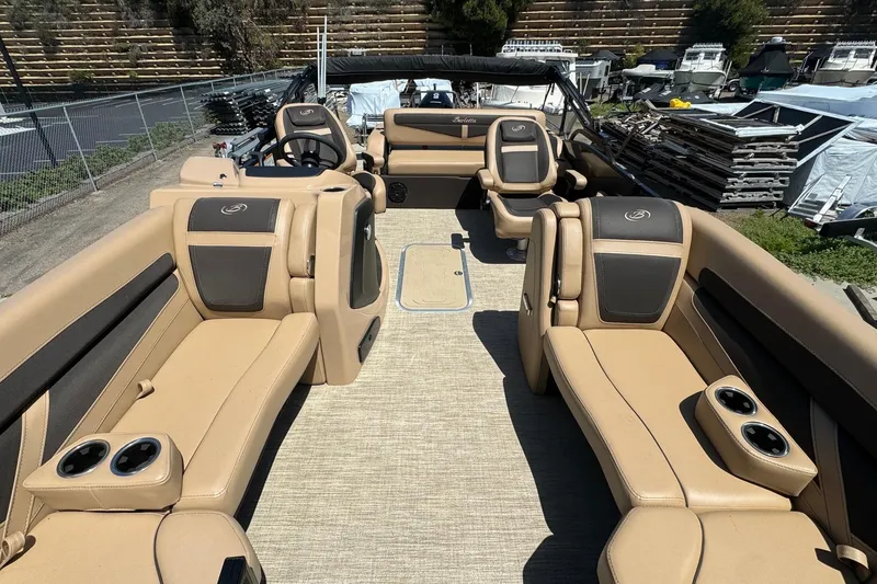 Slide: The Image of 2023 Barletta Cabrio 22UC pontoon boat interior with tan seating and cup holders. - 15
