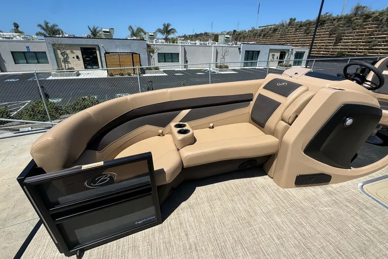 Slide: The Image of 2023 Barletta Cabrio 22UC boat interior with tan seating and cup holders. - 17