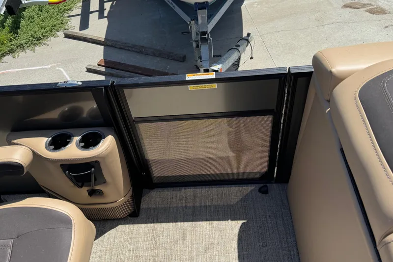 Slide: The Image of 2023 Barletta Cabrio 22UC boat interior with cup holders and seating. - 22