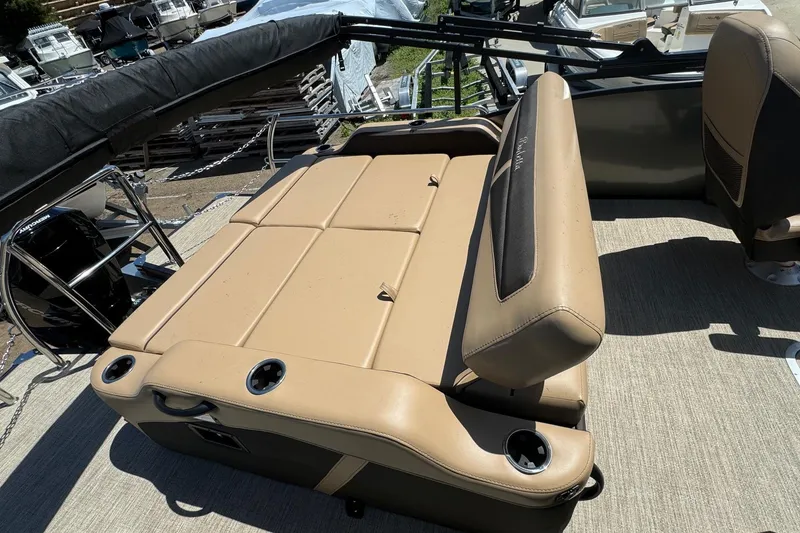 Slide: The Image of 2023 Barletta Cabrio 22UC boat interior with tan seating and cup holders. - 26