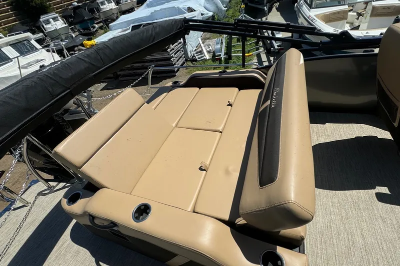 Slide: The Image of 2023 Barletta Cabrio 22UC boat interior with tan seating and cup holders. - 30