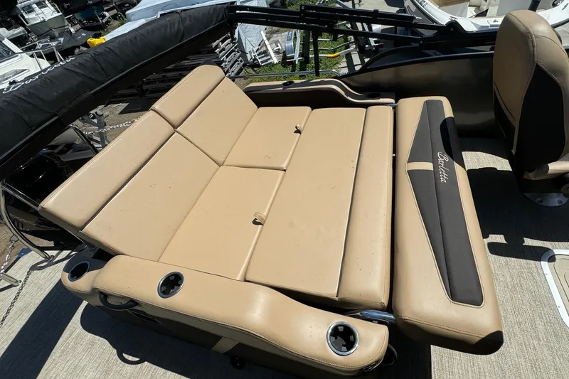 Slide: The Image of 2023 Barletta Cabrio 22UC boat interior with tan seating and cup holders. - 31