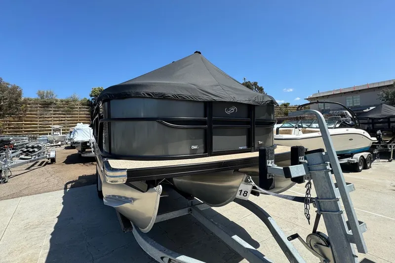 Slide: The Image of 2023 Barletta Cabrio 22UC pontoon boat on trailer, covered and parked outdoors. - 5