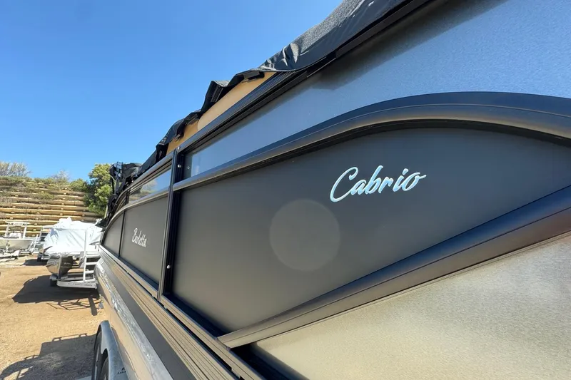 Slide: The Image of 2023 Barletta Cabrio 22UC pontoon boat side view under clear blue sky. - 7