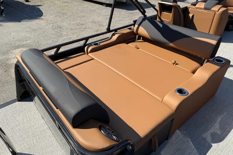 Slide: The Image of 2026 Tahoe Pontoon LTZ Versatile Rear Lounger with beige seating and cup holders. - 5