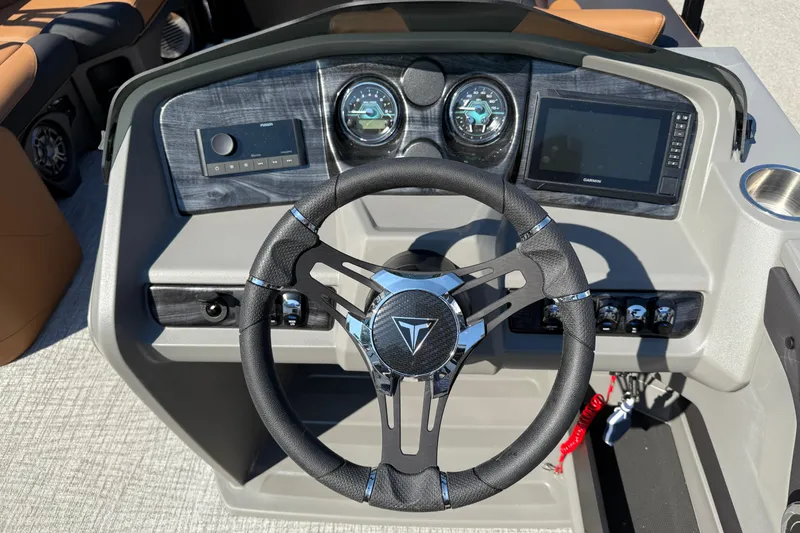 Slide: The Image of 2026 Tahoe Pontoon LTZ Versatile Rear Lounger dashboard with Garmin navigation system. - 9