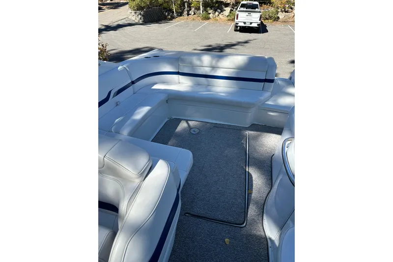 Slide: The Image of 2004 Formula 330 Sun Sport boat interior with white seating and blue accents. - 12