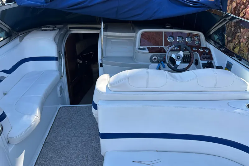 Slide: The Image of 2004 Formula 330 Sun Sport boat interior with white seating and control panel. - 14