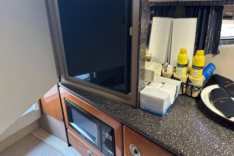 Slide: The Image of 2004 Formula 330 Sun Sport cabin with microwave, TV, and toiletries on counter. - 19