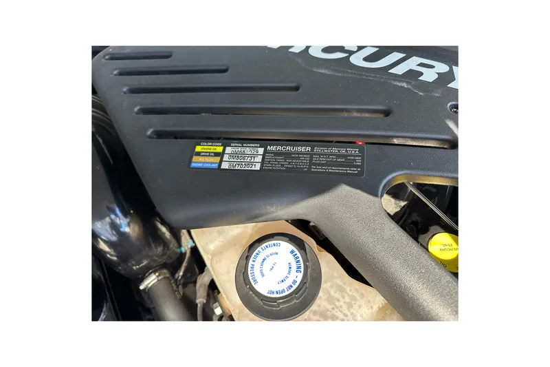 Slide: The Image of Engine compartment of 2004 Formula 330 Sun Sport with MerCruiser label and coolant cap. - 28