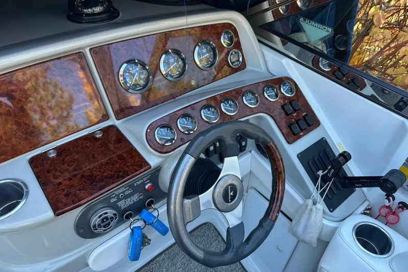 Slide: The Image of 2004 Formula 330 Sun Sport dashboard with wood accents and steering wheel. - 6