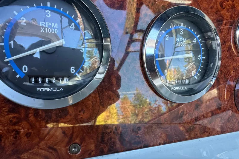 Slide: The Image of Dashboard of 2004 Formula 330 Sun Sport with RPM gauges and wood finish. - 7