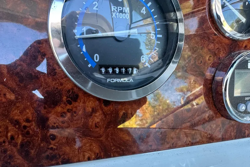 Slide: The Image of Close-up of 2004 Formula 330 Sun Sport RPM gauge on a wooden dashboard. - 8