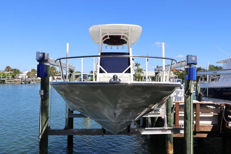 Slide: The Image of 2019 Boston Whaler 210 Montauk boat docked on a lift in a marina. - 1