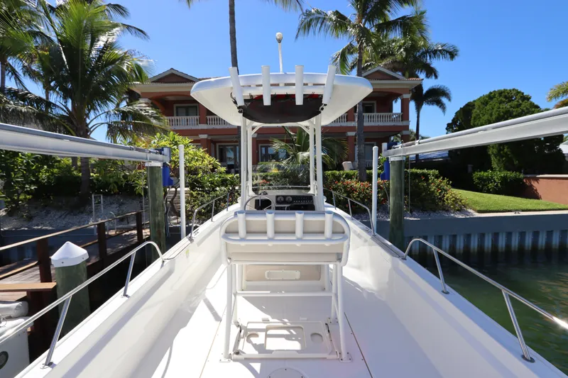 Slide: The Image of 2019 Boston Whaler 210 Montauk boat docked near tropical waterfront home. - 10