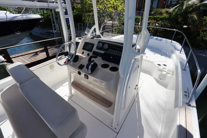 Slide: The Image of 2019 Boston Whaler 210 Montauk boat interior with steering console and seating. - 12