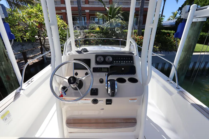 Slide: The Image of 2019 Boston Whaler 210 Montauk boat console with steering wheel and controls. - 14