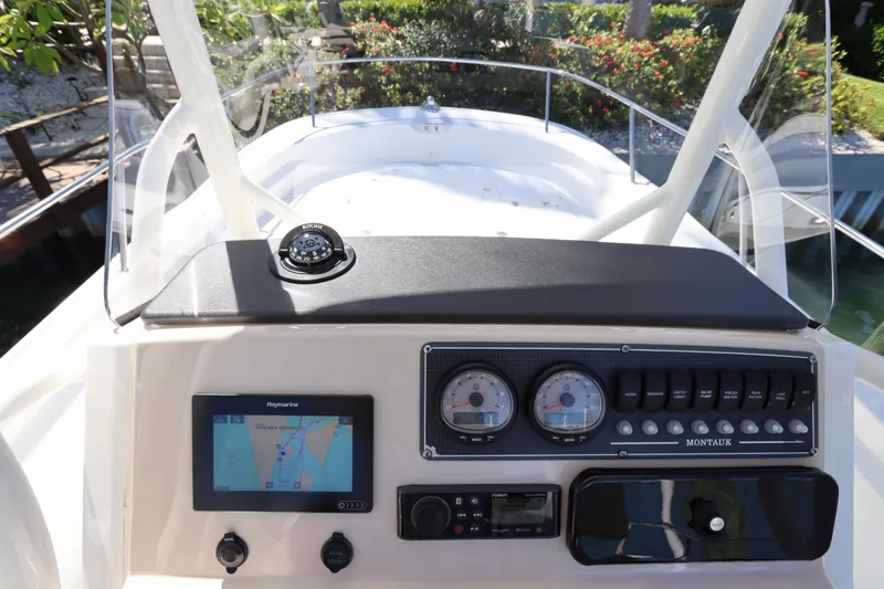 Slide: The Image of 2019 Boston Whaler 210 Montauk boat dashboard with navigation instruments and controls. - 16