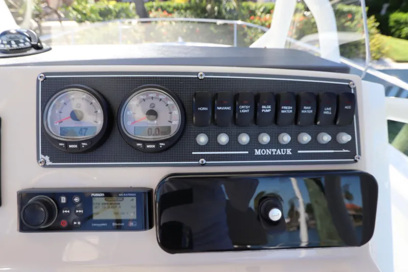 Slide: The Image of 2019 Boston Whaler 210 Montauk dashboard with gauges and control panel. - 18