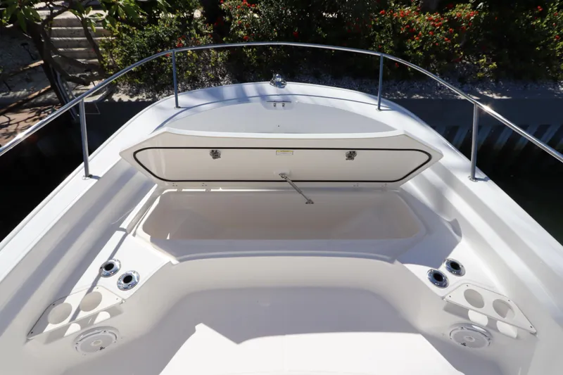Slide: The Image of 2019 Boston Whaler 210 Montauk boat interior with open storage compartment. - 22