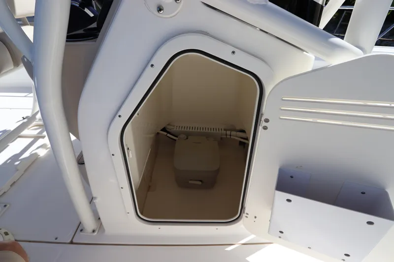 Slide: The Image of 2019 Boston Whaler 210 Montauk boat storage compartment with portable toilet. - 25