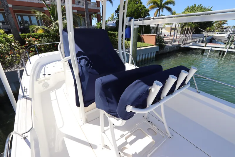 Slide: The Image of 2019 Boston Whaler 210 Montauk boat interior with blue seating and rod holders. - 9
