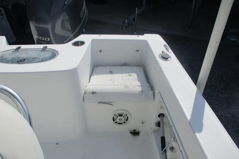 Slide: The Image of 2015 Sea Hunt Triton 225 boat interior with Yamaha 200 engine and seating area. - 10