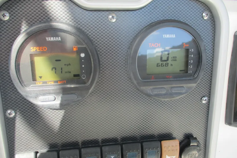 Slide: The Image of Dashboard of a 2015 Sea Hunt Triton 225 with Yamaha speed and tachometer gauges. - 12