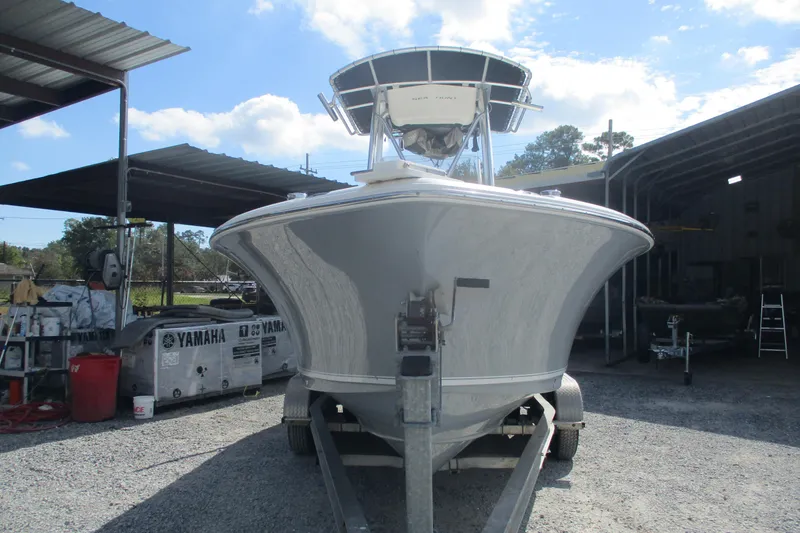 Slide: The Image of 2015 Sea Hunt Triton 225 boat on trailer in outdoor storage area. - 2