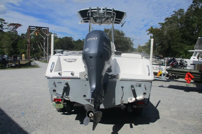 Slide: The Image of 2015 Sea Hunt Triton 225 boat with Yamaha 200 engine, parked outdoors. - 5