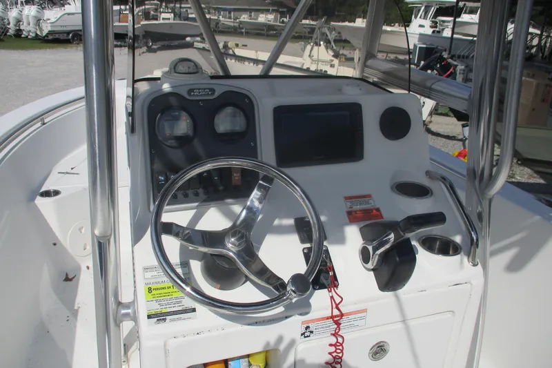 Slide: The Image of 2015 Sea Hunt Triton 225 boat console with steering wheel and controls. - 6