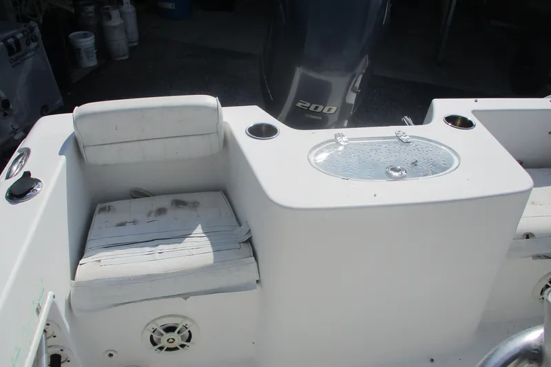 Slide: The Image of 2015 Sea Hunt Triton 225 boat interior with seating and livewell. - 9