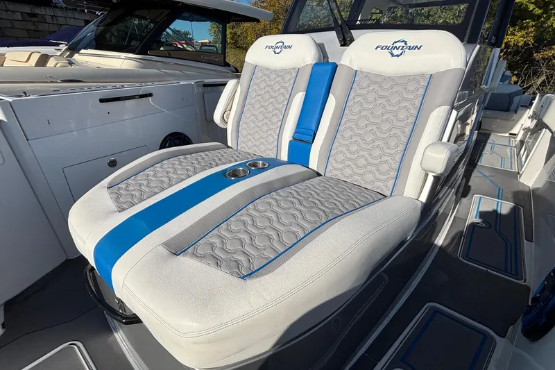 Slide: The Image of 2024 Fountain 38 SCX boat interior with stylish gray and blue seating. - 15