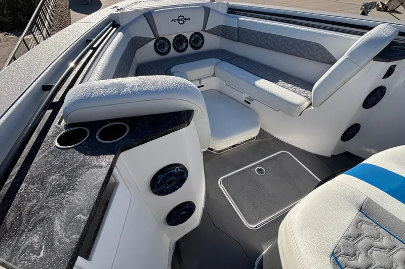 Slide: The Image of 2024 Fountain 38 SCX boat interior with seating, cup holders, and speakers. - 19