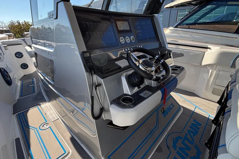 Slide: The Image of 2024 Fountain 38 SCX boat cockpit with modern controls and steering wheel. - 23