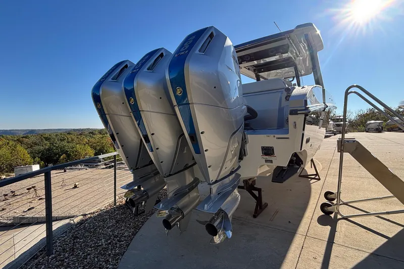 Slide: The Image of 2024 Fountain 38 SCX boat with triple outboard engines under a clear blue sky. - 3