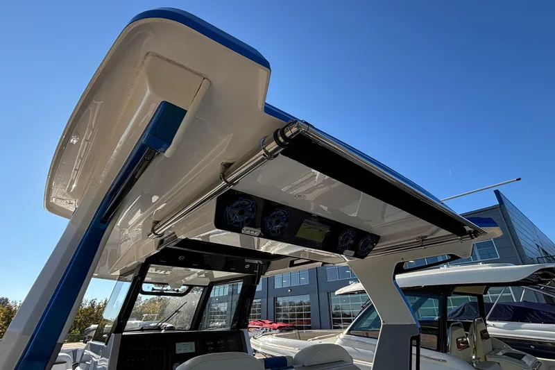 Slide: The Image of 2024 Fountain 38 SCX boat with advanced audio system and sleek design under clear blue sky. - 30