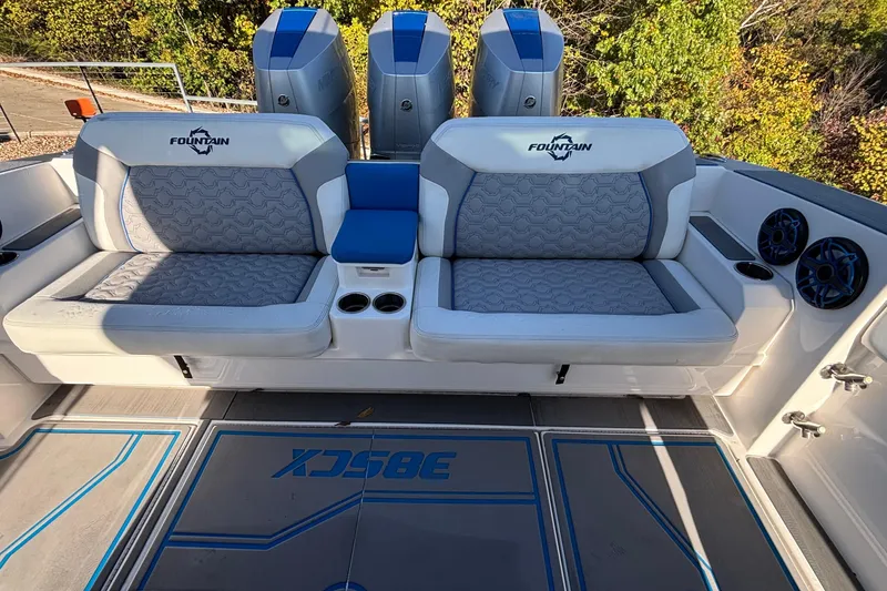 Slide: The Image of 2024 Fountain 38 SCX boat interior with cushioned seating and triple engines. - 31