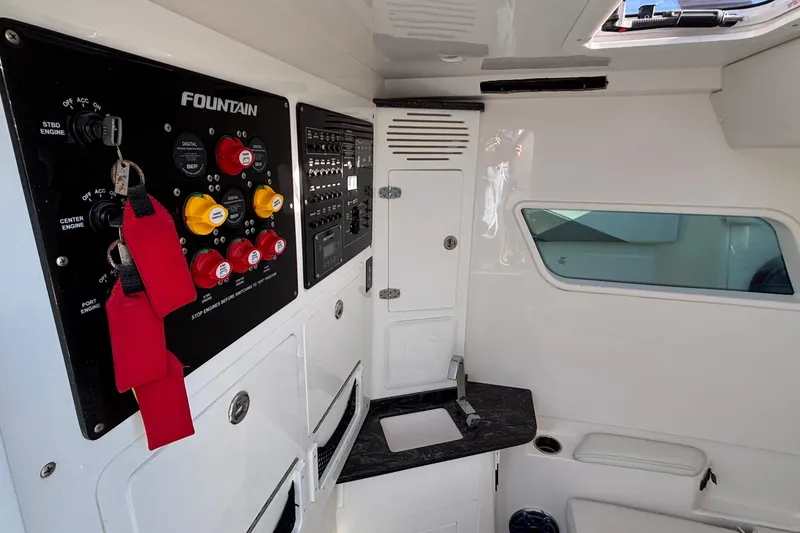 Slide: The Image of 2024 Fountain 38 SCX boat interior with control panel and compact sink area. - 6