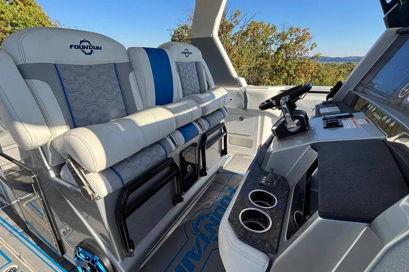 Slide: The Image of 2024 Fountain 38 SCX boat interior with luxury seating and modern dashboard. - 9