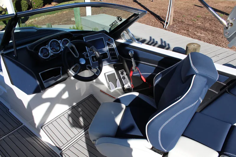 Slide: The Image of 2019 MasterCraft XT22 boat interior with steering wheel and blue seating. - 10