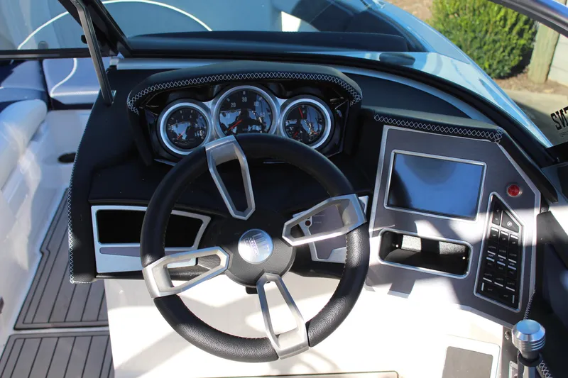 Slide: The Image of 2019 MasterCraft XT22 dashboard with steering wheel, gauges, and touchscreen display. - 11