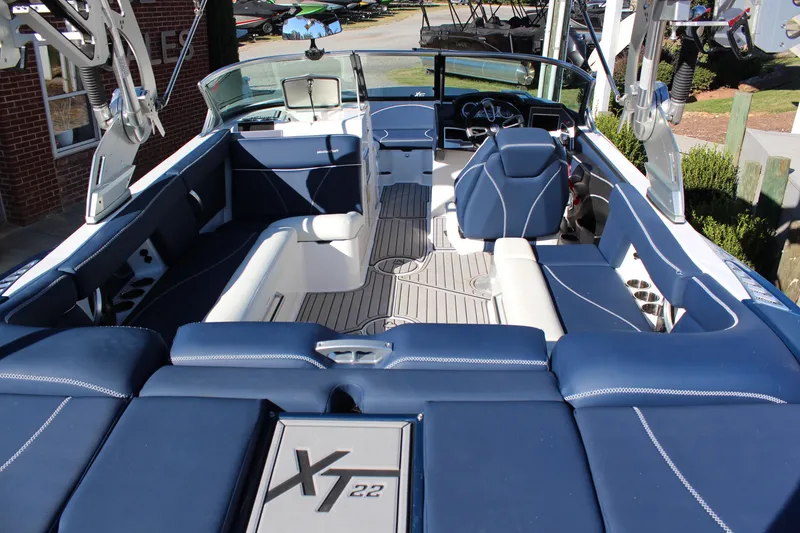 Slide: The Image of 2019 MasterCraft XT22 boat interior with blue seating and modern design. - 6
