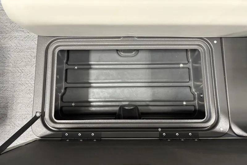 Slide: The Image of 2026 Sun Tracker Fishin' Barge 22 DLX seat, gray and white upholstery, on boat deck. - 12