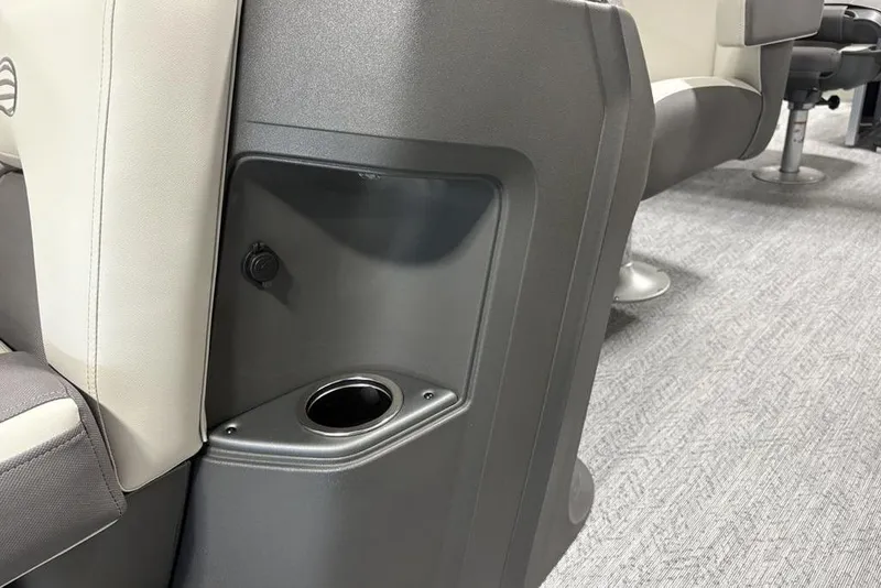 Slide: The Image of 2026 Sun Tracker Fishin' Barge 22 DLX interior with beige seating and metal railing. - 15