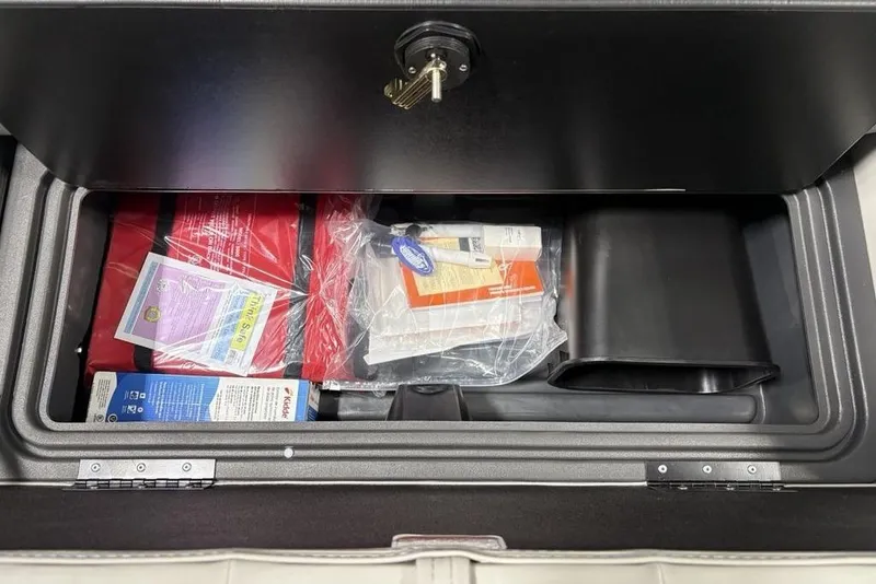 Slide: The Image of Storage compartment in 2026 Sun Tracker Fishin' Barge 22 DLX boat interior. - 25