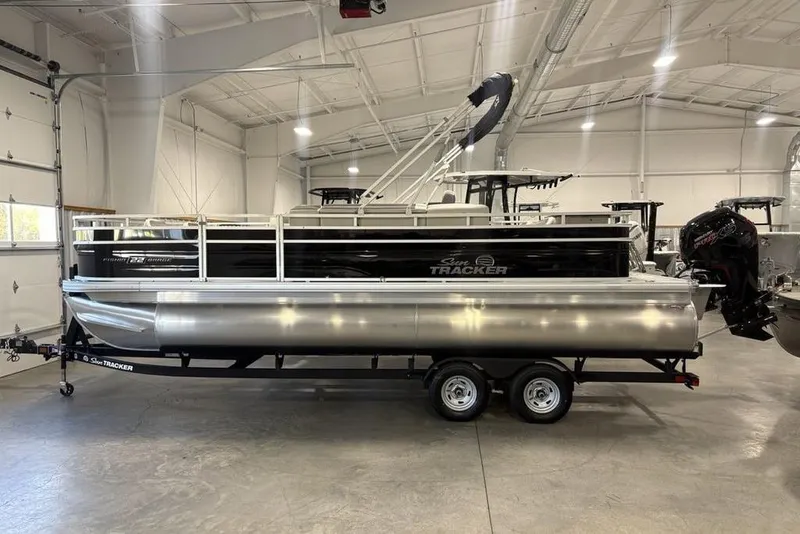 Slide: The Image of 2026 Sun Tracker Fishin' Barge 22 DLX fishing station with cup holders and measuring board. - 3