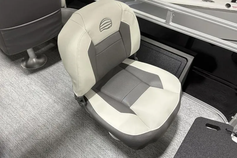 Slide: The Image of 2026 Sun Tracker Fishin' Barge 22 DLX interior with seating and control console. - 34